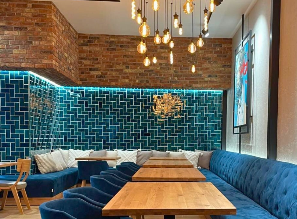Ceramic mosaic tiles - rectangles, petrol blue color, tiled wall in a restaurant